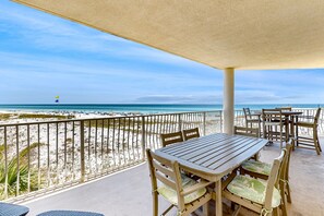 Enjoy a beachside retreat with a covered outdoor seating area featuring a table and chairs.