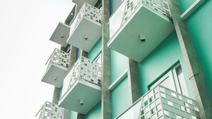 A modern building with multiple balconies and large windows. - Aruuman Hotel Simpanglima Semarang (Semarang)