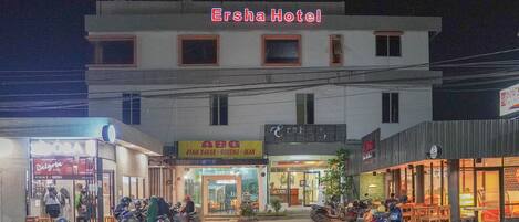 A building with a sign reading "Ersha Hotel" at the top.