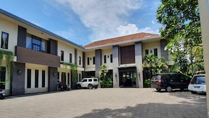 A modern building with a tiled roof and a paved courtyard.