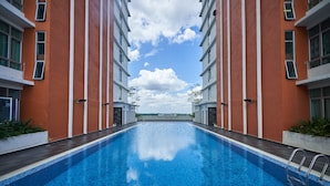 A swimming pool with a clear view of the sky and buildings in the background. - OYO Home 89748 Classic 3 Br The Arc (Cyberjaya)