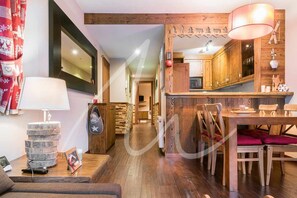 Cozy living space with a central dining table and comfortable seating area.