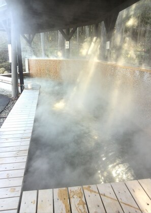 A hot spring area with a wooden deck and a stone wall. - VILLA YAITA ONSEN  hot spa (Yaita)