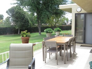 Relax on the patio surrounded by lush greenery and enjoy the peaceful atmosphere.