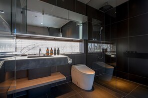A modern bathroom with a glass-enclosed shower, a toilet, and a vanity with a mirror and sink. - Odile by Hokkaido Tracks (Kutchan)