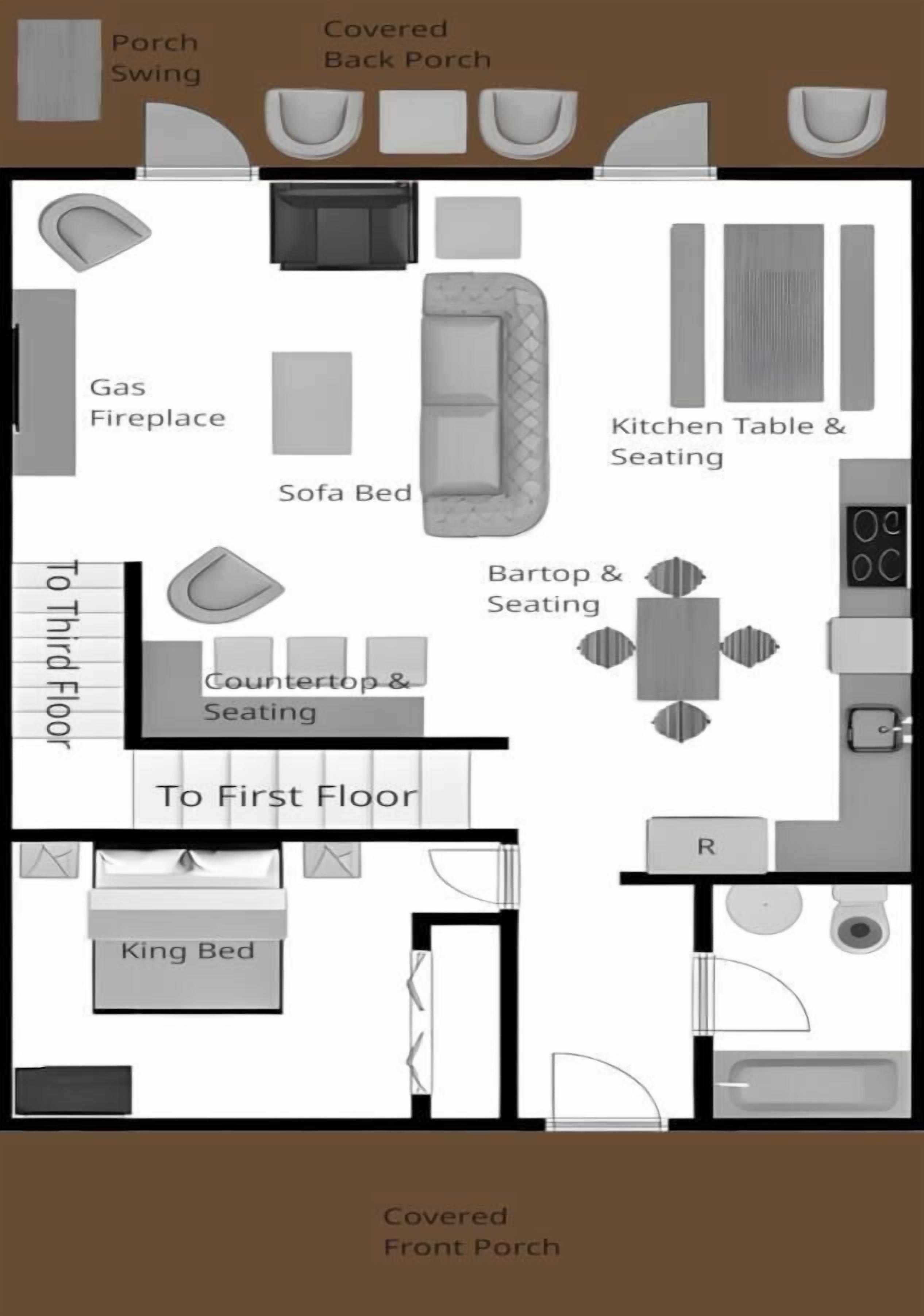 Un aménagement de chambre d’hôtel comprenant une cheminée au gaz, un canapé-lit, une kitchenette, un grand lit et une véranda à l’avant.