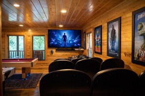 A cozy room with a pool table, comfortable seating, a large flat-screen TV, and movie posters on the walls. - All the amenities you need for R&R and/or fun, can sleep 18, Game Room. (gatlinburg)