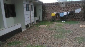 A house with a gravel driveway and a stone wall.