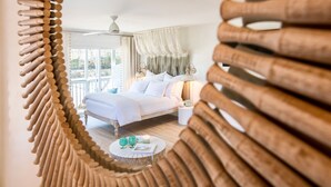 A bedroom with a bed, bedside table, lamp, and a view of the outdoors. - FlipFlopsOn II • 80 Steps to the Beach • FL 30A • Gulf Coast (Inlet Beach)