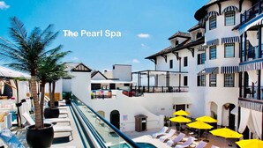 A poolside area with lounge chairs and umbrellas at The Pearl Spa. - FlipFlopsOn II • 80 Steps to the Beach • FL 30A • Gulf Coast (Inlet Beach)