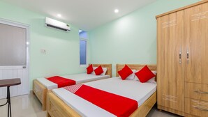 A hotel room with two beds, a wardrobe, a window, and an air conditioning unit. - OYO 898 Phuong Thao Hotel (Nha Trang)
