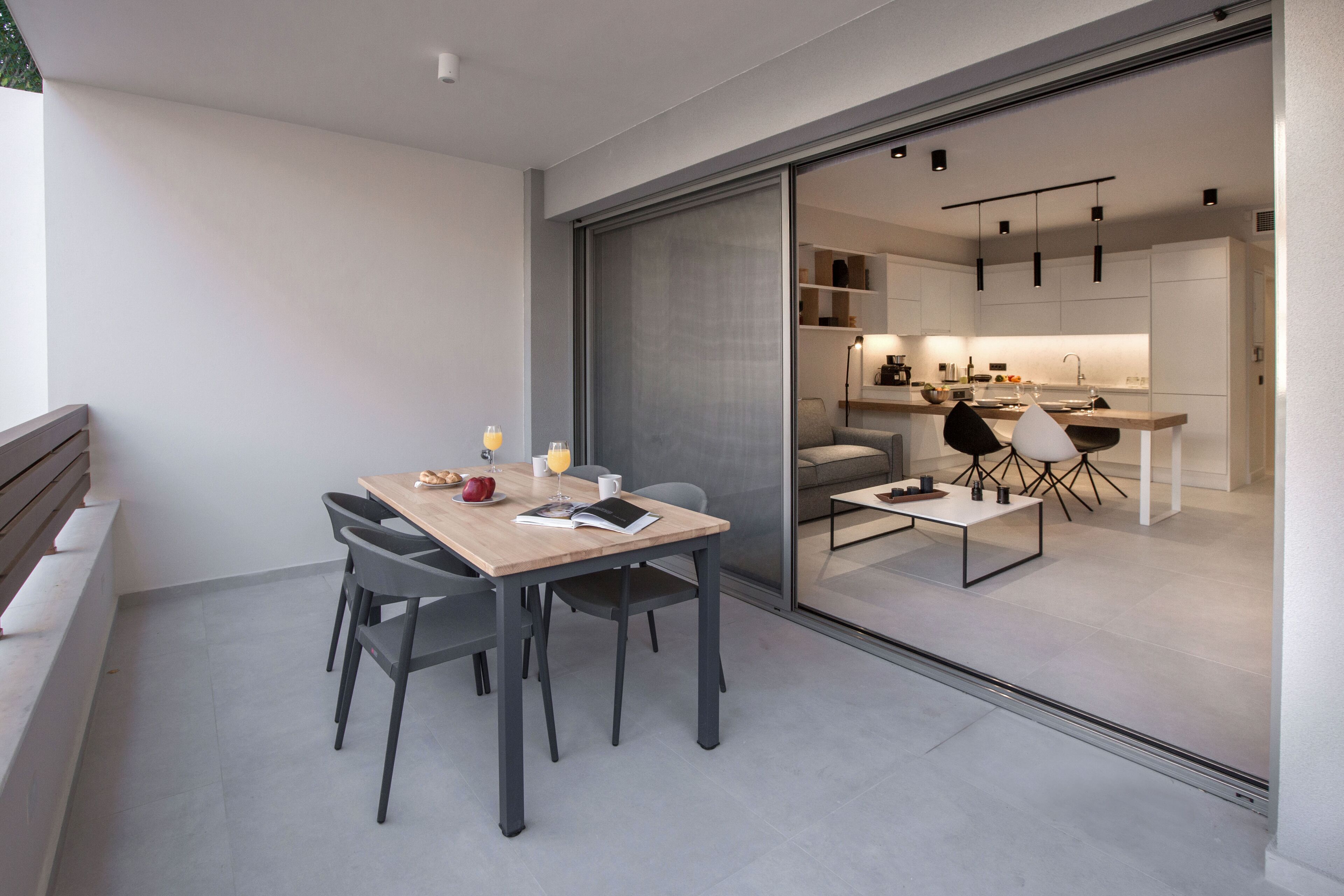 A modern kitchen with a sliding glass door leading to a dining area.