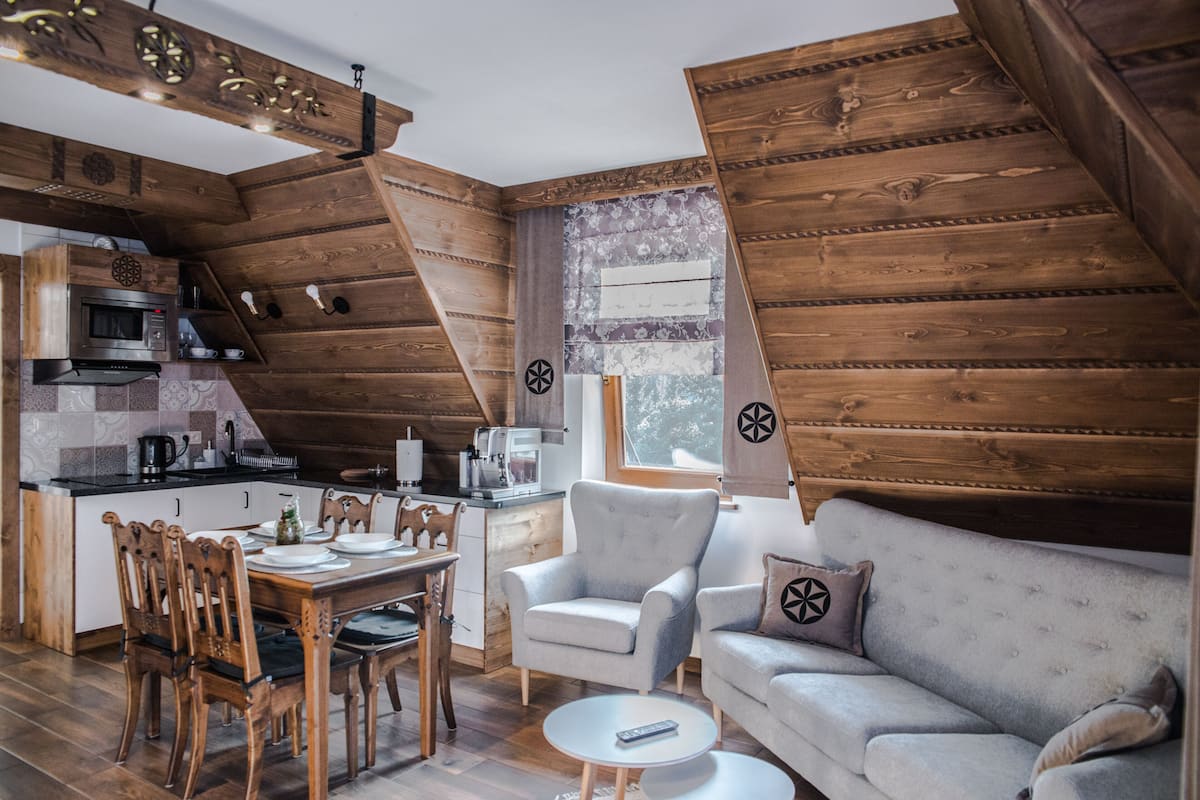 A cozy loft-style living space with a dining area, kitchen, and seating area.