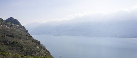 A mountainous landscape with a lake, a clear sky, and distant mountains.