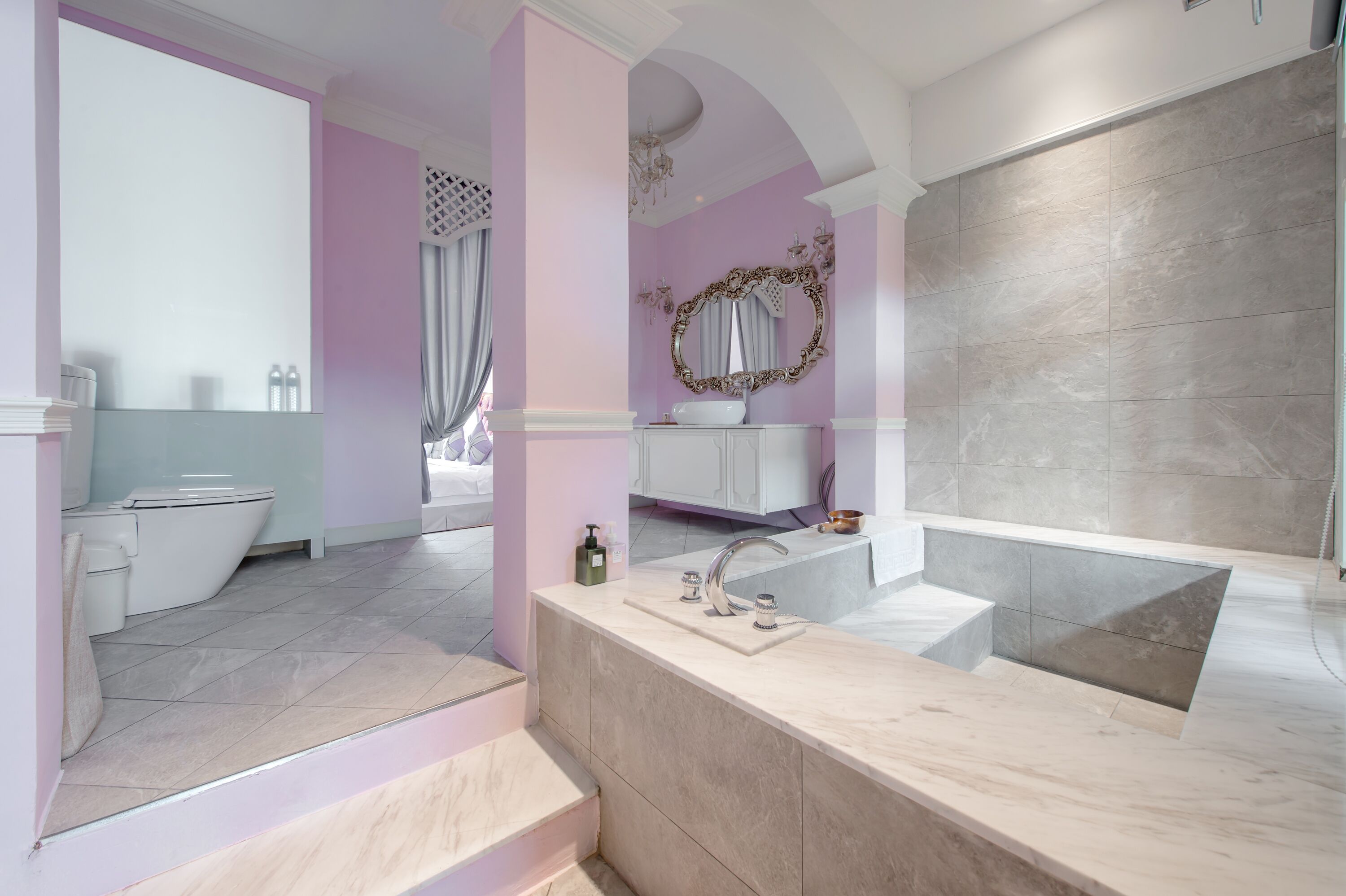 A modern bathroom with a vanity, sink, and bathtub.