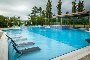 Seasonal outdoor pool, open 9:00 AM to 10:00 PM, pool umbrellas