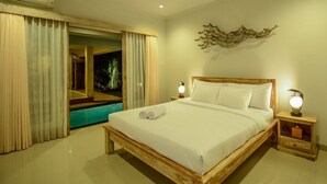 A hotel room with a wooden bed, two bedside lamps, a nightstand, a large window with curtains, and a view of a swimming pool. - Villa Airin (Canggu)
