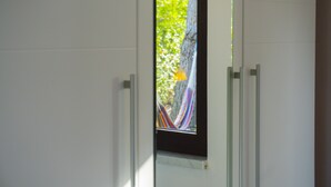 A door with a view of a tree and a hammock outside. - Victorious VIScovery Red (Vis)