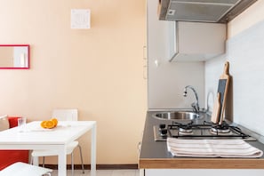 Enjoy cooking in this well-equipped kitchen with a gas stove, stainless steel sink, and ample countertop space.