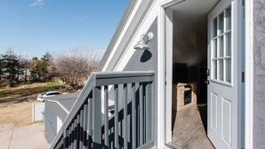 A house with a grey exterior, a wooden deck, and a visible garage door. - This house is a 11 bedroom(s), 8 bathrooms, located in Hurricane, UT. (Hurricane)