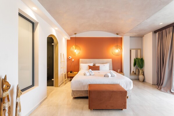 A modern bedroom with a large bed, a bench, and a mirror. - Cocooning Suites by Blue Carpet (Kassandra)