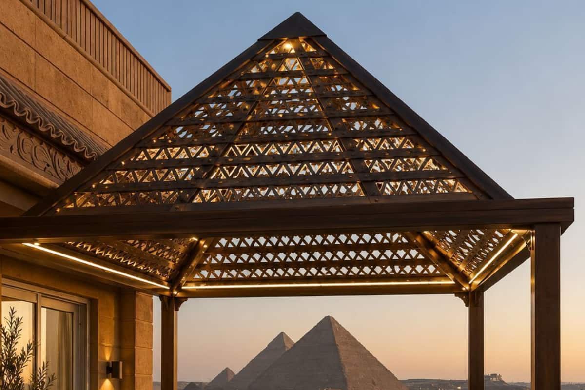 A rooftop terrace with a view of the pyramids, a pergola, seating, and a sign for 'GARDENIA PYRAMIDS.'