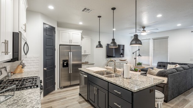 A modern kitchen with a central island, stainless steel appliances, and pendant lighting. - 3BR Sleeps 18 w/ 3 Kings & Bunk Loft - Near Pool (St. George)