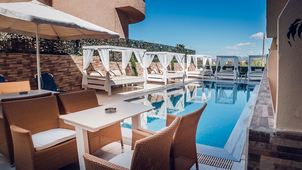 An outdoor pool area with wicker furniture and white canopies. - Cloud 9 Hotel Shisha & Cocktail Bar - Adults Only (Hersonissos)