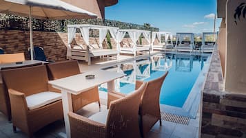 Seasonal outdoor pool, open noon to 7:30 PM, pool umbrellas