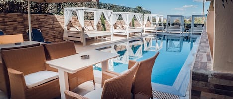 Seasonal outdoor pool, pool umbrellas, pool loungers