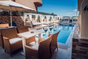 An outdoor pool area with wicker furniture and white canopies. - Cloud 9 Hotel Shisha & Cocktail Bar - Adults Only (Hersonissos)