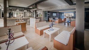 A modern lounge area with sofas, tables, and a bar. - Cloud 9 Hotel Shisha & Cocktail Bar - Adults Only (Hersonissos)