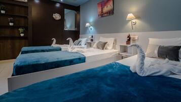 Triple Room | Minibar, in-room safe, laptop workspace, iron/ironing board