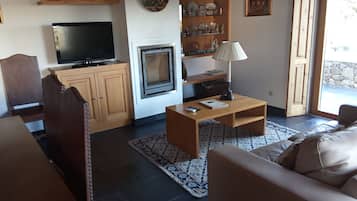 Departamento, 1 habitación | Área de sala de estar | Televisión de pantalla plana