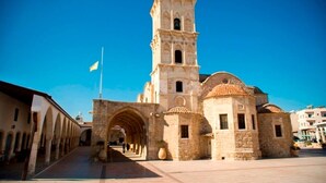 A historic building with a prominent bell tower and arched entrance. - Private Roof Top Terrace Overlooking Pool in Pyla (Pyla)