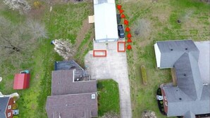 An aerial view of a residential area with houses, a parking lot, and a river. - Delightful Guest Room Close to Hendersonville’s Downtown (Hendersonville)