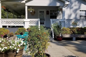 A residential house with a covered porch, a front door, and a mailbox.