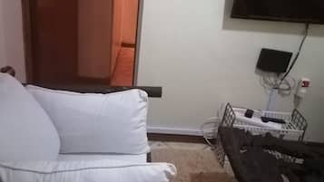 Apartment, 2 Bedrooms | Living room | 32-inch flat-screen TV with cable channels, TV