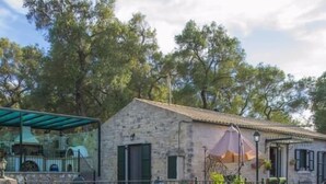 A stone building with a sign reading "Sula Strata". - Su La Strata house  by CorfuEscapes (Paxos)