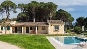 A villa with a swimming pool, outdoor seating, and a view of the surrounding trees. -  Villa Pine Forest  (Corfu)