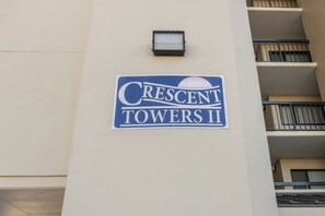 A sign for Crescent Towers II with a balcony railing and a small light fixture above it. - Updated!!! Crescent Towers II 708,  2 BR Ocean Front Luxury Condo with Pool (North Myrtle Beach)
