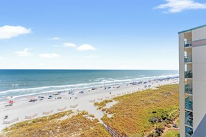 A beach with a building on the right.