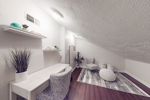 Cozy retreat with a shelf, plush bench, and potted plant.