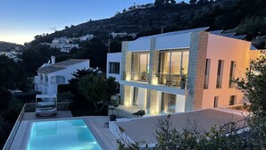 A modern two-story house with a swimming pool, stone facade, and large windows. - House - Sleeps 8 - Pool - Garden - Parking (Javea)