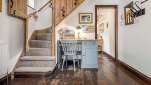 A staircase leading to a desk area with a chair, a lamp, and a framed picture on the wall. - The Willows - Woodland Cottage with Log Burner (Christchurch)