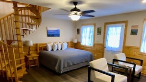 A bedroom with a bed, a desk, a chair, a wooden staircase, and a ceiling fan. - Hot Tub& Mountain Views - Min to National Park! (Sevierville)
