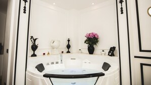 A modern bathroom with a glass-enclosed bathtub, white walls, and black decorative moldings. - TS. Peter's Fashion suite with jacuzzi Vaticano-Rome (roma)