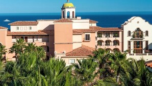 A coastal hotel with a prominent yellow dome, terracotta roofs, and a view of the sea. - Sheraton Hacienda Del Mar Easter Week 4/6/-4/13 (Hacienda del Mar Cabo San Lucas)