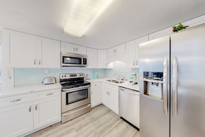 Enjoy cooking in this well-equipped kitchen with a microwave, oven, refrigerator, dishwasher, and sink.