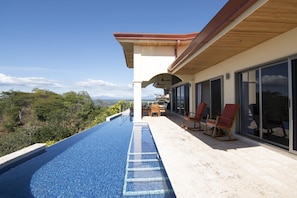 A modern outdoor pool area with a clear view of the surrounding landscape. - Casa Alegria (Sardinal)